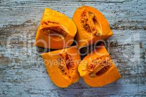 Ripe pumpkin pieces on the gray table