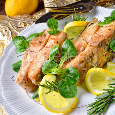 Fried carp fillet on wintry salad