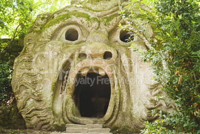 the mouth of the ogre building inside the Park of the Monsters in Bomarzo, Italy