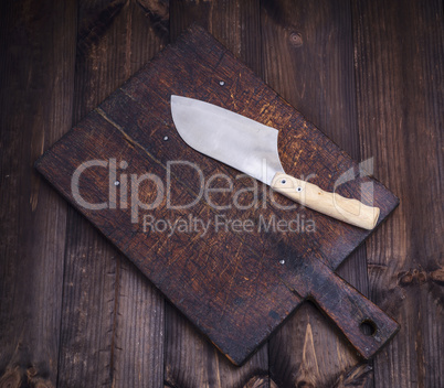 old kitchen cutting brown board and a knife for cutting meat