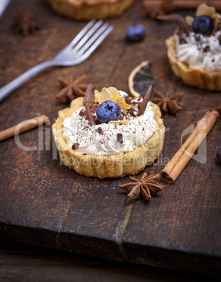 sweet cakes with white cream sprinkled with chocolate