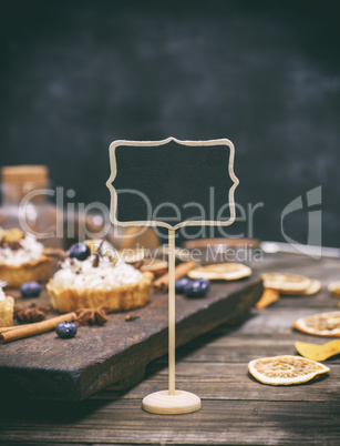 Empty wooden sign with a black surface