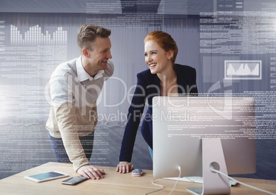 Business couple working on laptop with screen text interface