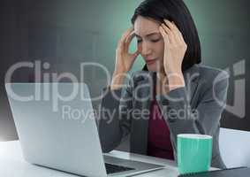 Businesswoman working on laptop with green background