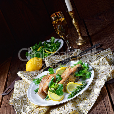 Fried carp fillet on wintry salad