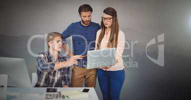 Three people working on laptop