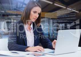Businesswoman working on laptop with screen text interface