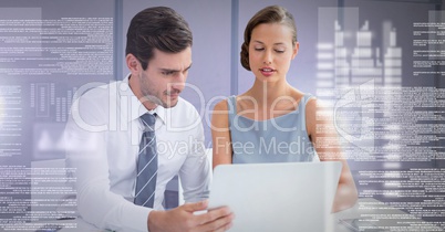Business couple working on laptop with screen text interface