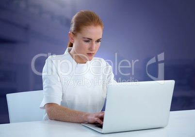 Businesswoman working on laptop with purple background