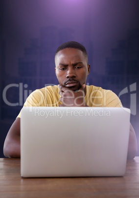 Businessman working on laptop with purple background