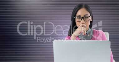 Businesswoman working on laptop with pink grey background
