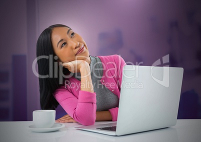 Businesswoman working on laptop with pink background