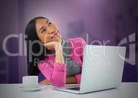 Businesswoman working on laptop with pink background