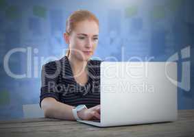 Businesswoman working on laptop with blue background