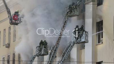Firefighters in Action with Water to Put out the Fire