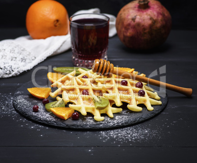 baked Belgian waffles and a glass of pomegranate juice