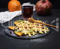 baked Belgian waffles and a glass of pomegranate juice