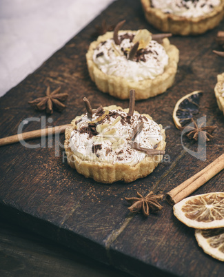 sweet cakes with white cream and chocolate powder