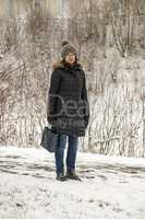 Woman with shopping bag in winter