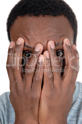 African man holding his hands over face