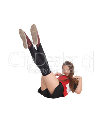 Young woman lying on the floor, legs up
