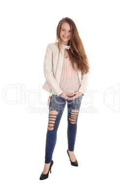 Young woman standing in jeans and jacket