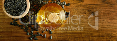 Seeds and oil sunflower on a wooden background. Flat lay, top vi