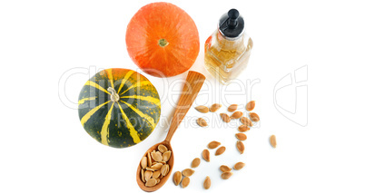 Oil, seeds and pumpkin fruits isolated on white background. Wide