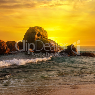 Sea landscape with rocky island and the sunrise.