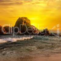 Sea landscape with rocky island and the sunrise.