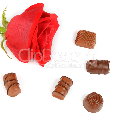 Assortment of chocolates and red rose isolated on white backgrou