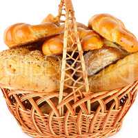Bread and baked goods in a wicker basket isolated on a white bac