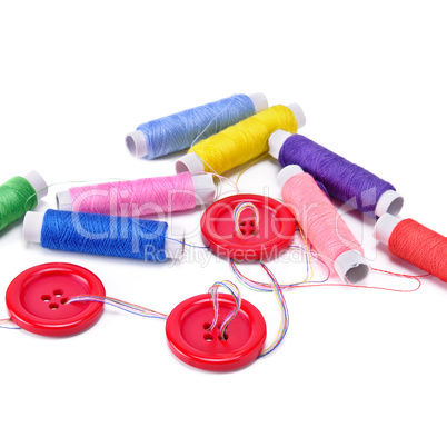 Sewing thread and buttons isolated on white background.