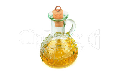 Glass jug with vegetable oil isolated on white .