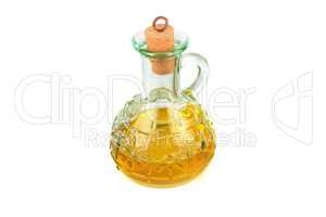 Glass jug with vegetable oil isolated on white .
