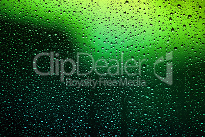 Bright water droplets on glass
