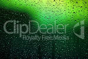 Bright water droplets on glass
