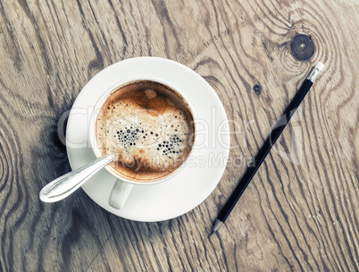 Coffee cup and pencil