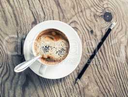Coffee cup and pencil