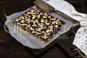 baked chocolate cake sprinkled with almonds