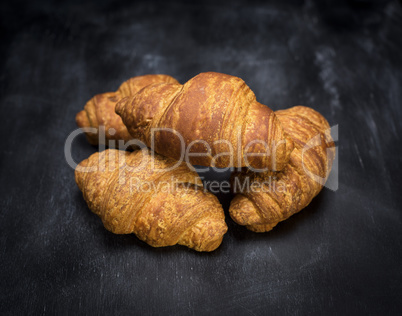 croissants on a black wooden background