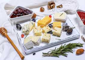small pieces of brie cheese, roquefort, camembert, cheddar and c