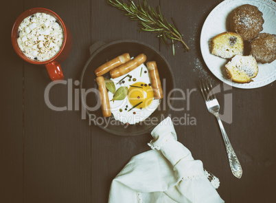 fried eggs with sausages, cocoa with marshmallows