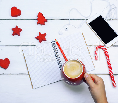 ceramic red cup with black coffee in a female hand