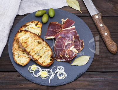 pieces of jamon and white fried bread for a sandwich