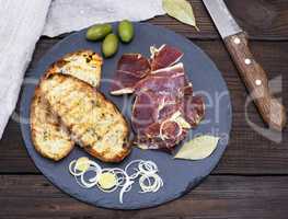 pieces of jamon and white fried bread for a sandwich