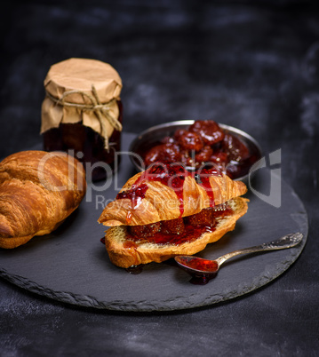 baked croissant with strawberry jam
