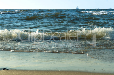 ship in the sea on the horizon, Sea waves on the beach, a storm in the Baltic sea