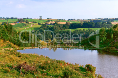 landscape lake in the distance, lake and picturesque forest and field in the distance