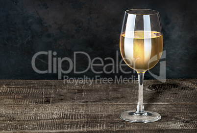Glass of white wine on a wooden table